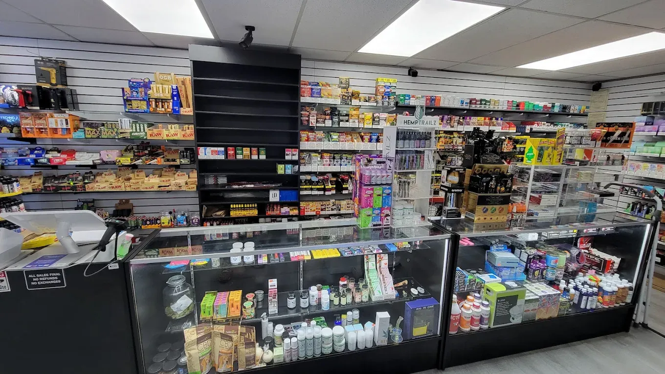 Smoke N' Stuff store interior with organized dark shelving and product displays