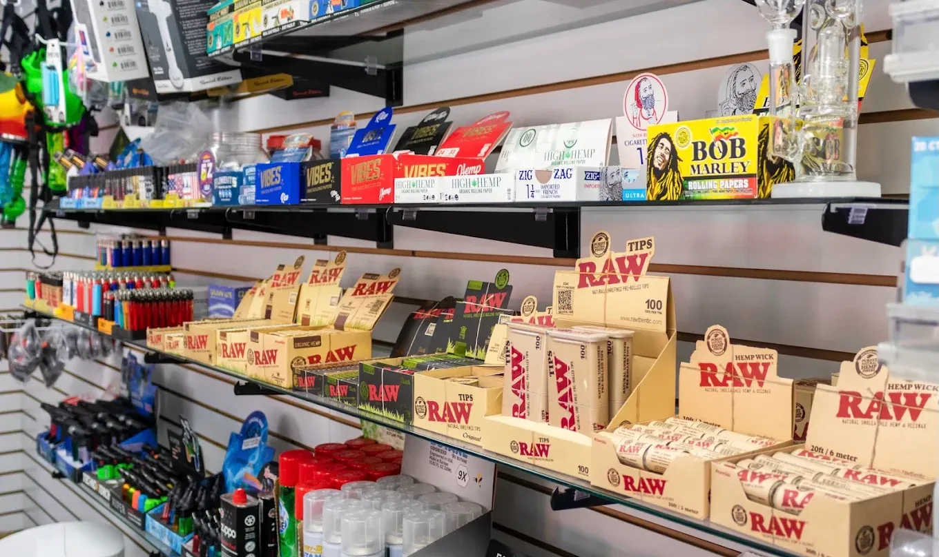 Rolling papers and wraps including RAW brand on black slatwall display