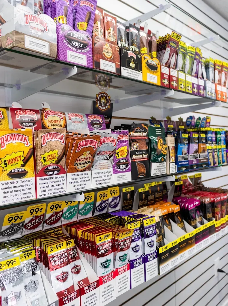 Backwoods, Game, and tobacco wraps on organized white shelving